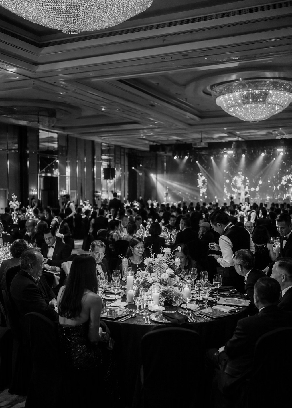 Company dinner and dance in a Singapore hotel ballroom produced by Haute Events, with banquet tables and stage lighting