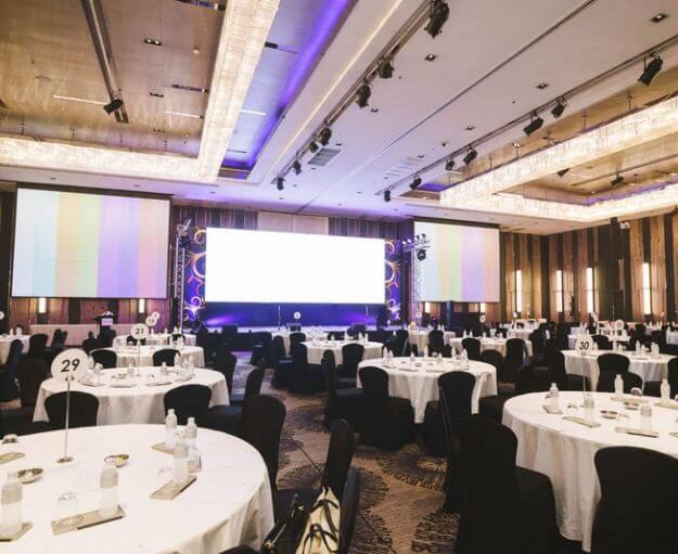 Corporate ballroom event with staging and AV managed by Haute Events Singapore